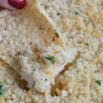 dipping a chip into jalapeno popper dip