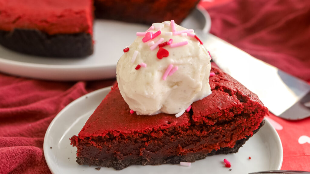 Red velvet brownie pie slice with ice cream on top