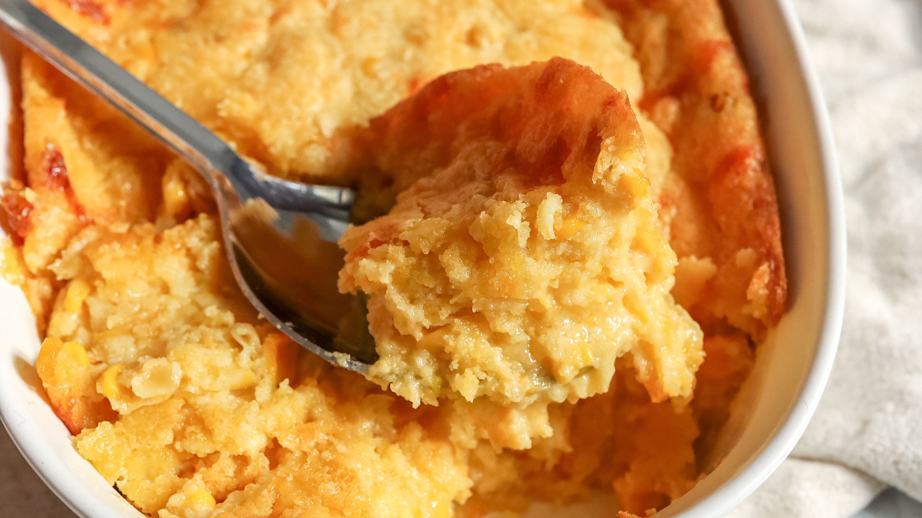 close up of a spoon of corn casserole