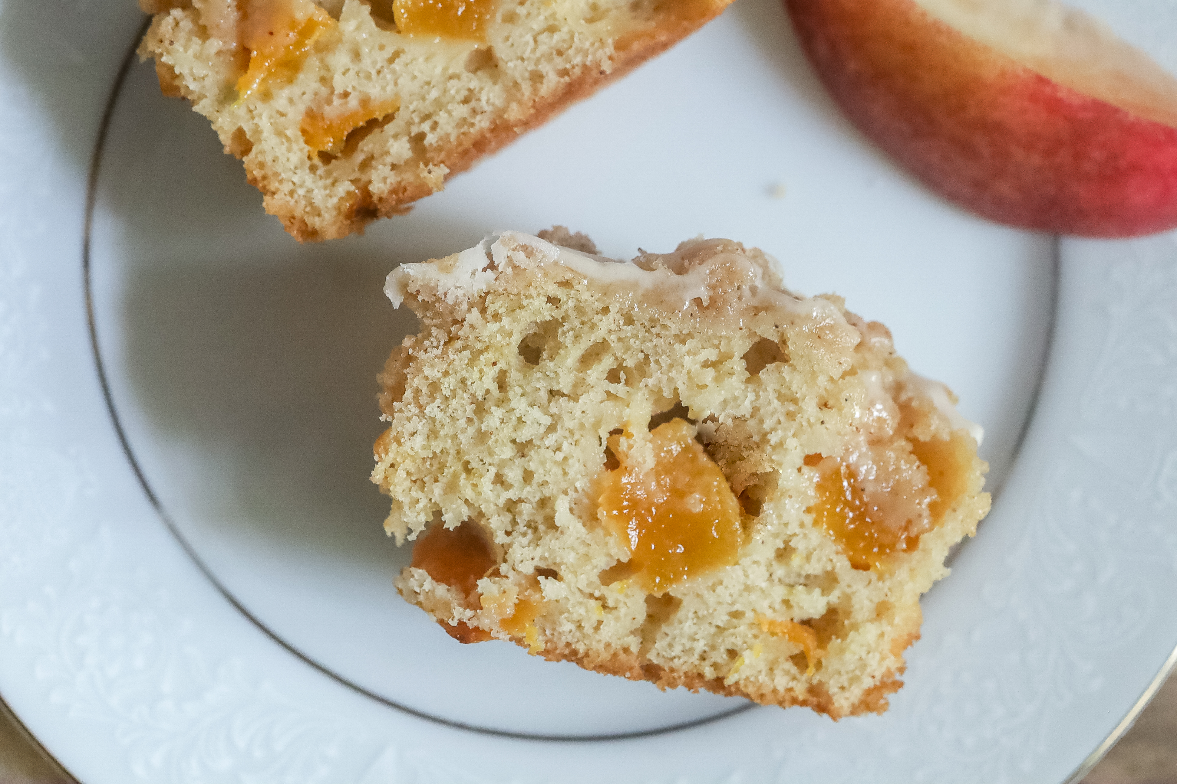 close up of a cut up peach cobbler muffin