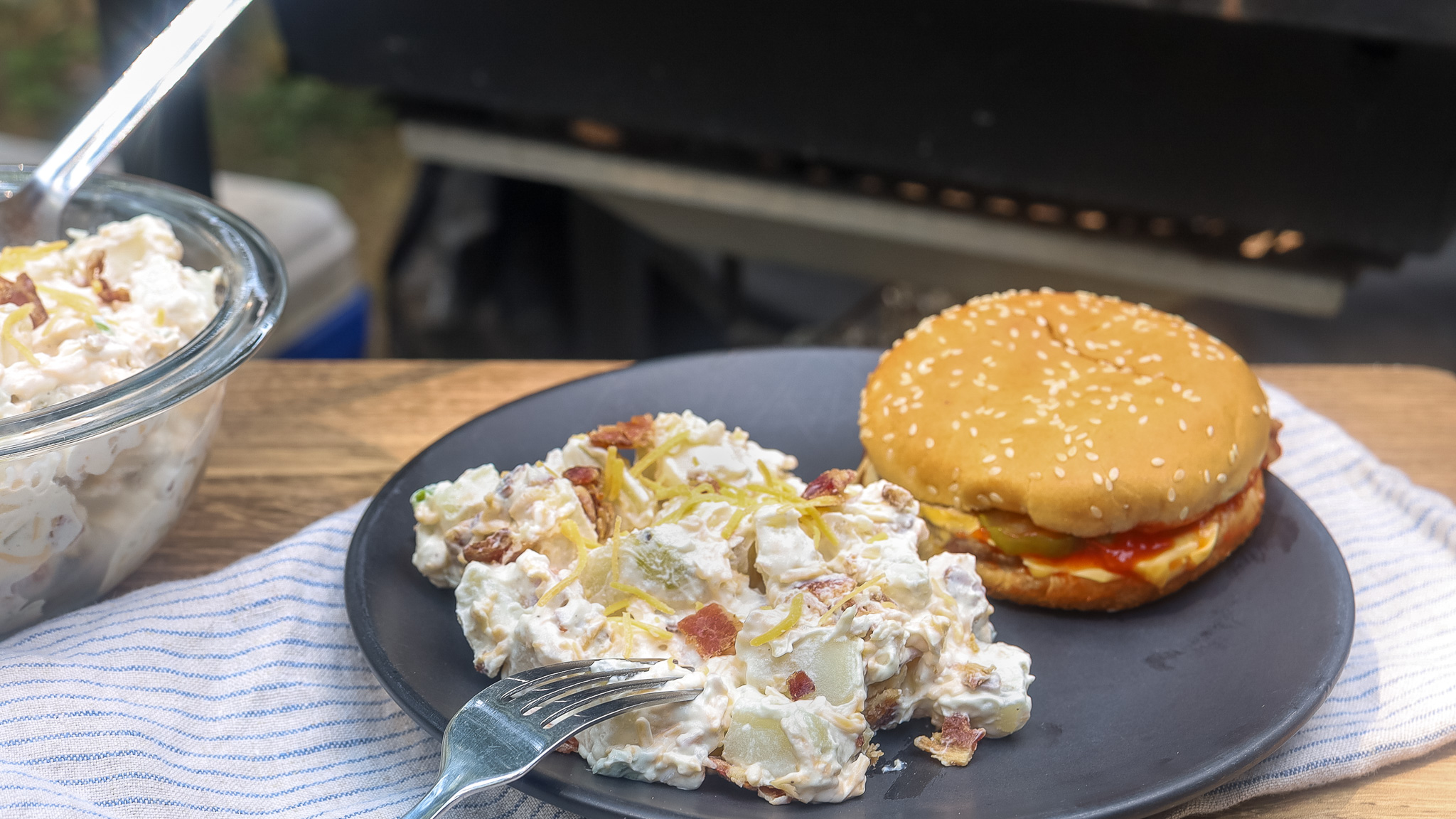 loaded baked potato salad outside by a grill