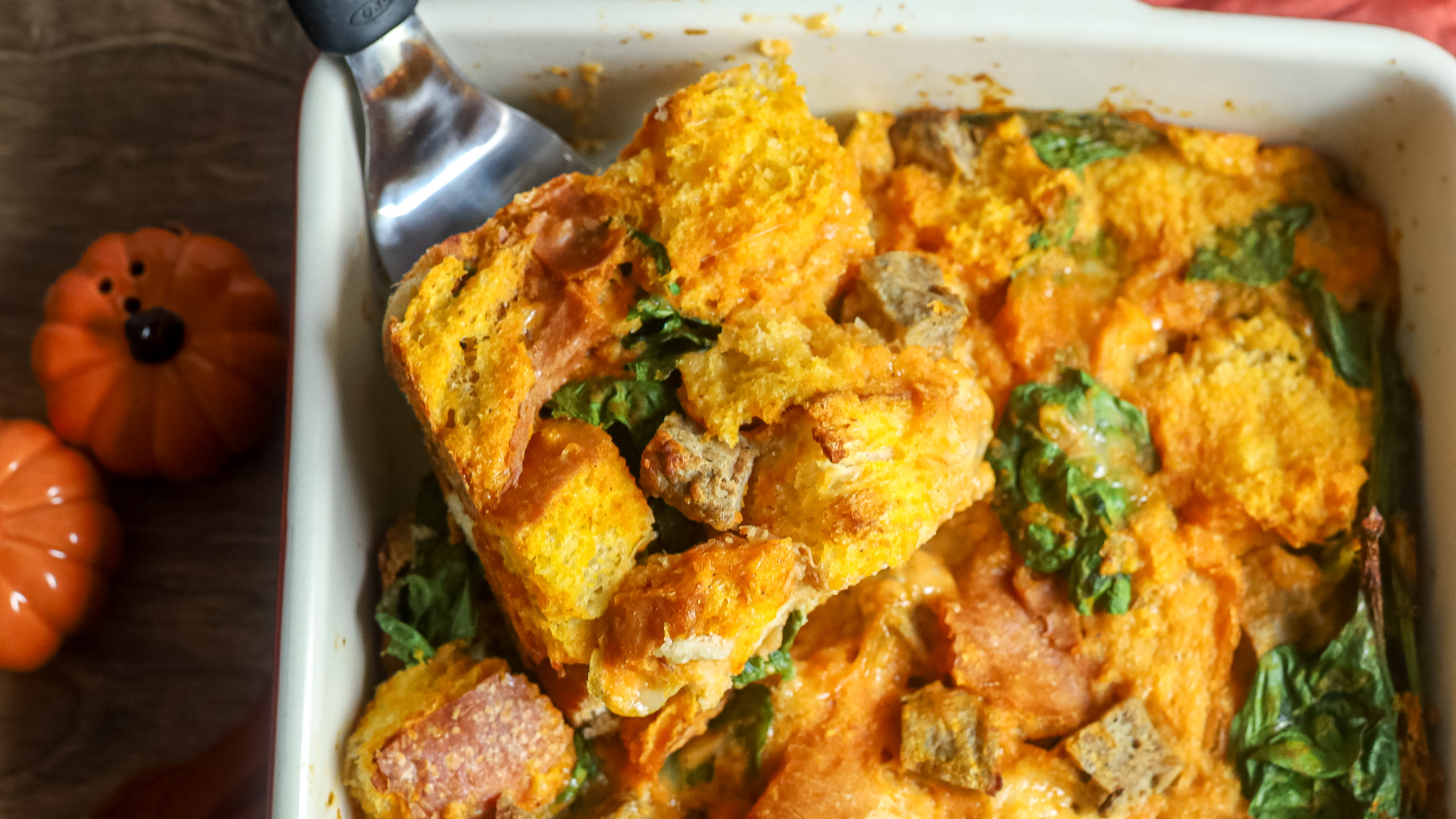 a slice of pumpkin strata being cut
