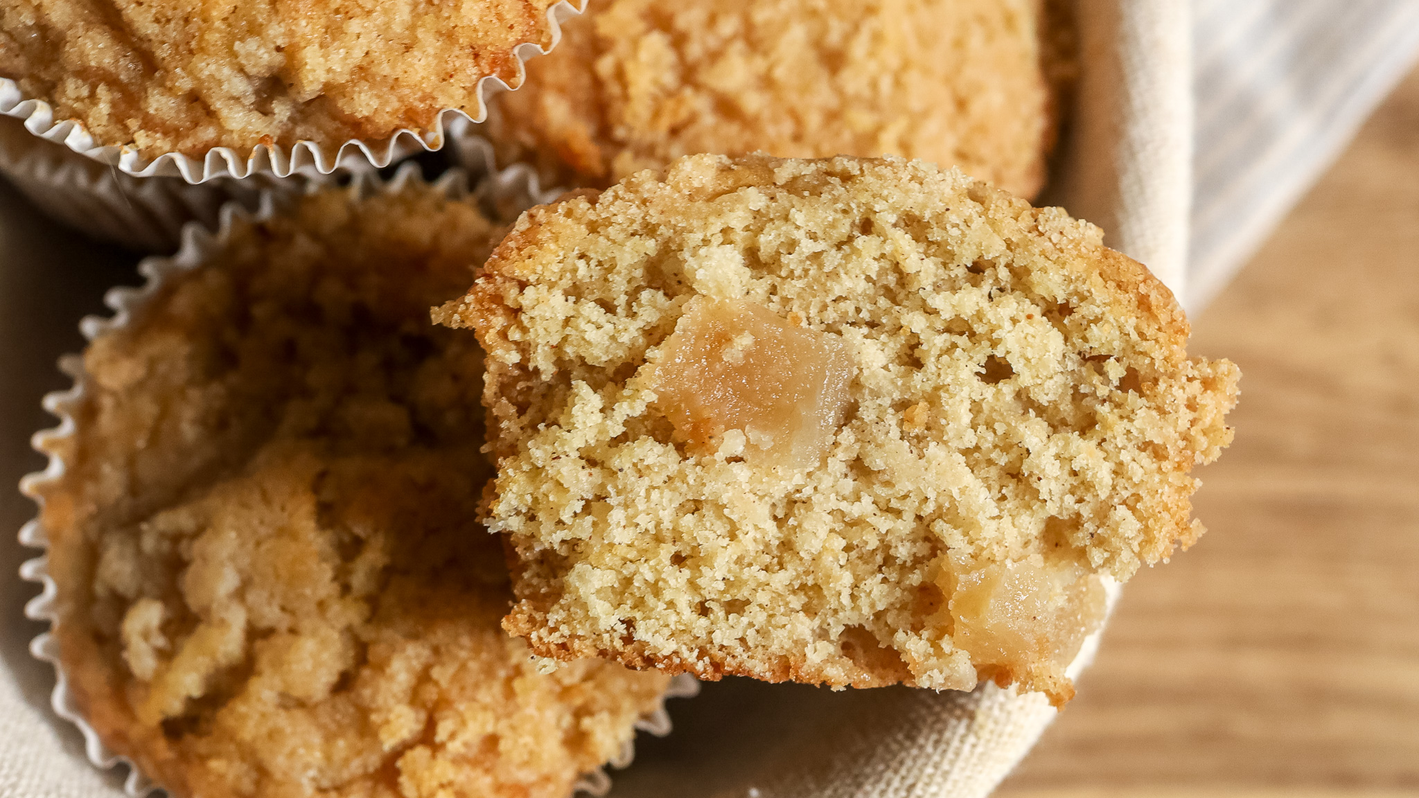 close up of a sliced apple pie muffin