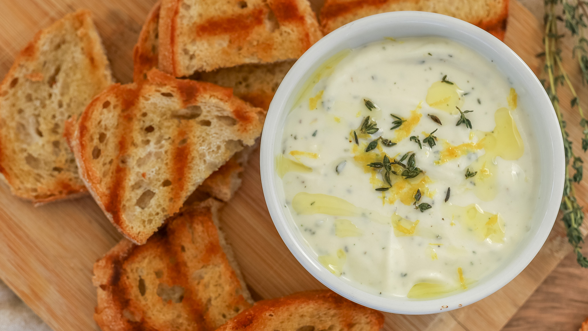 overhead photo of a bowl of whipped ricotta and toasts
