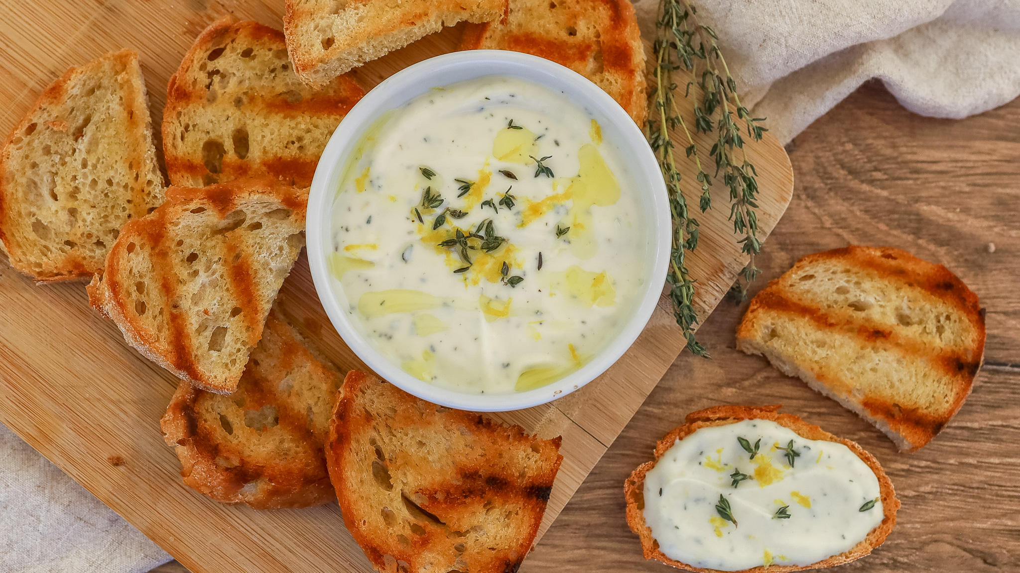 overhead photo of a scene with whipped ricotta with lemon, thyme and honey