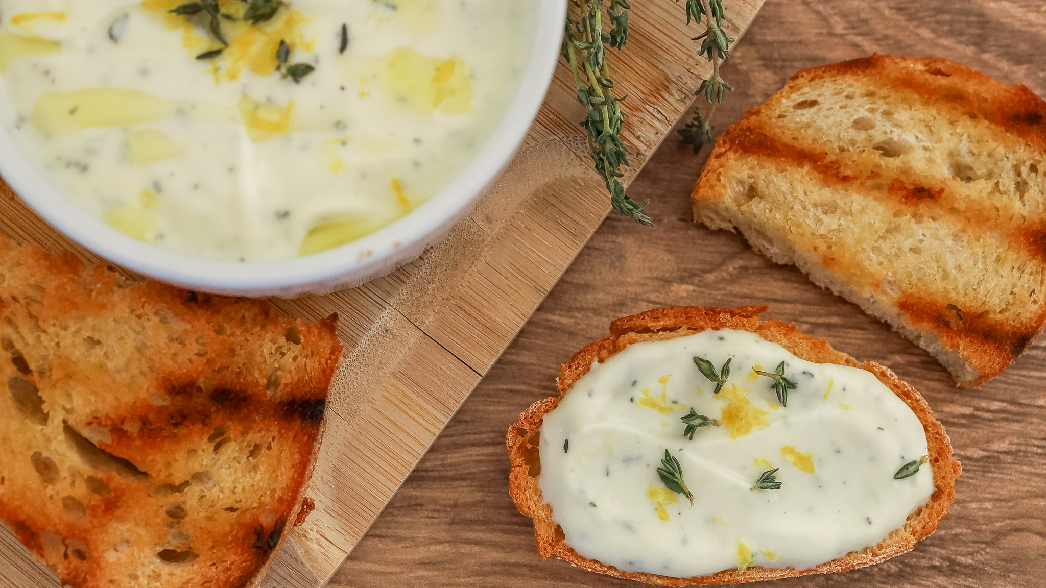 close up photo on a toast spread with whipped ricotta with lemon, thyme and honey