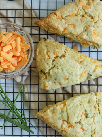 Cheddar herb scones on a cooling rack