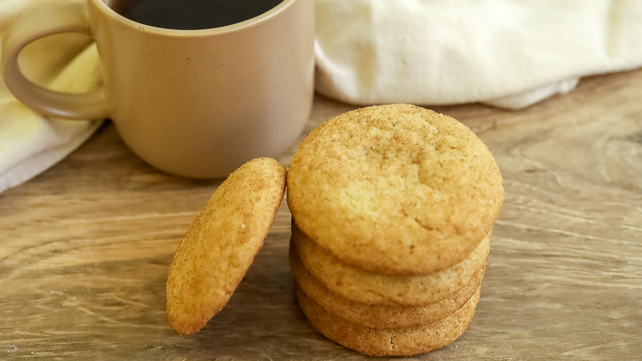 side photo of snickerdoodles with coffee